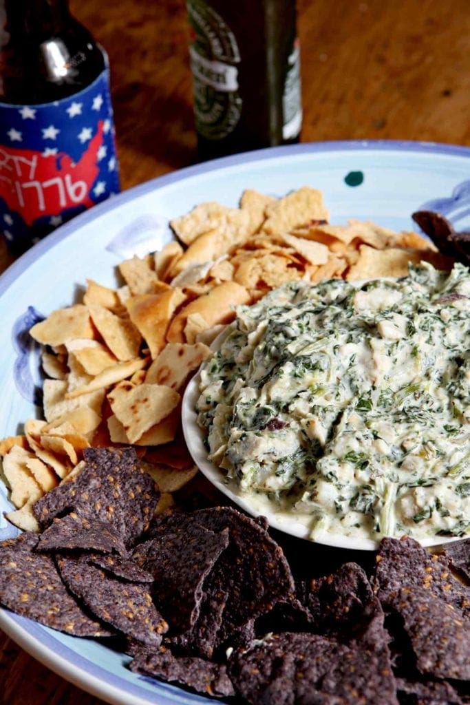 spinach artichoke dip in a bowl with chips