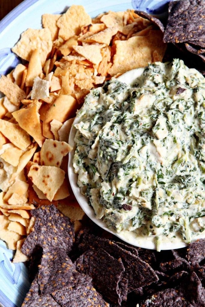 spinach artichoke dip in a bowl with chips