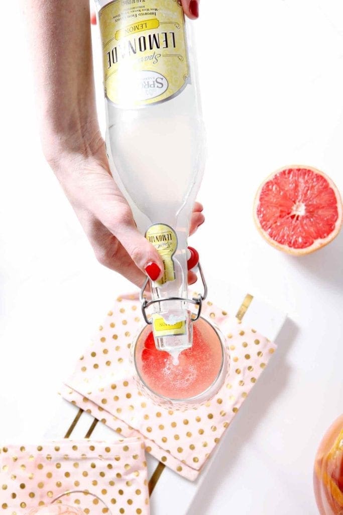 pouring lemonade in sparkling grapefruit sangria