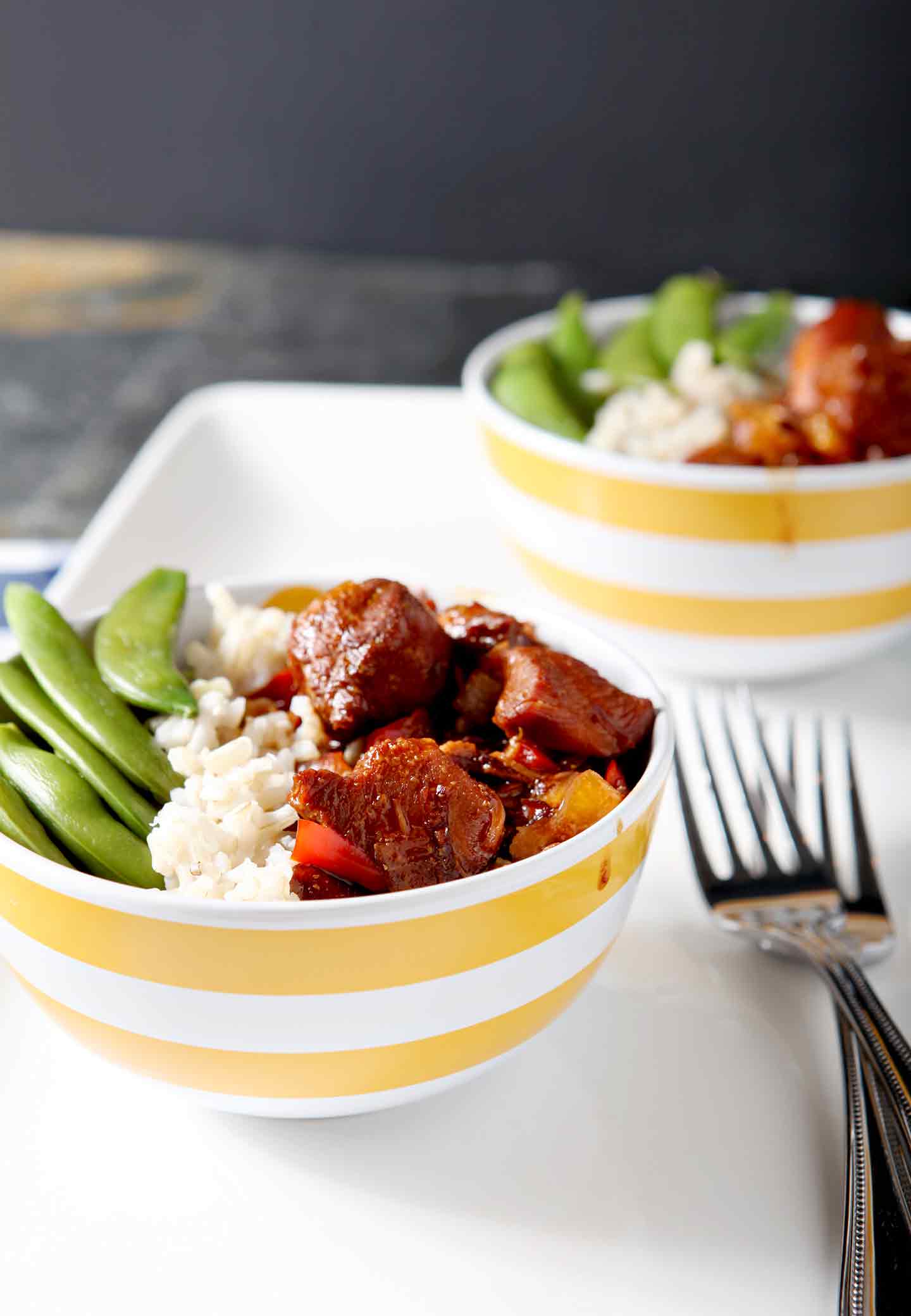 honey sriracha chicken rice bowls with forks