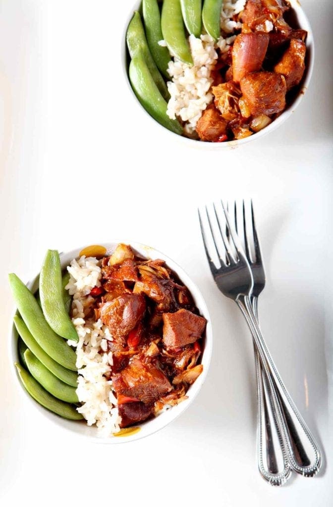 two honey sriracha chicken rice bowls with forks