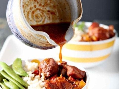 pouring honey sriracha sauce on a rice bowl