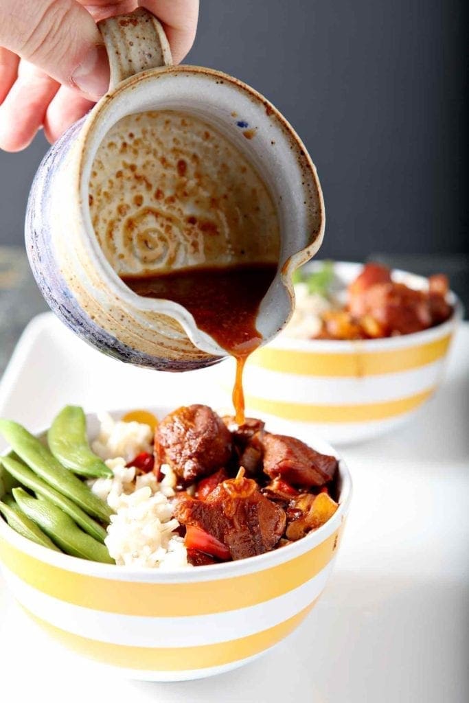 pouring honey sriracha sauce on a rice bowl