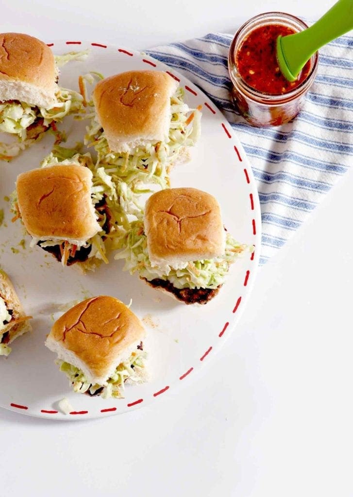 Overhead image of burger bites on a platter with spicy vinegar sauce