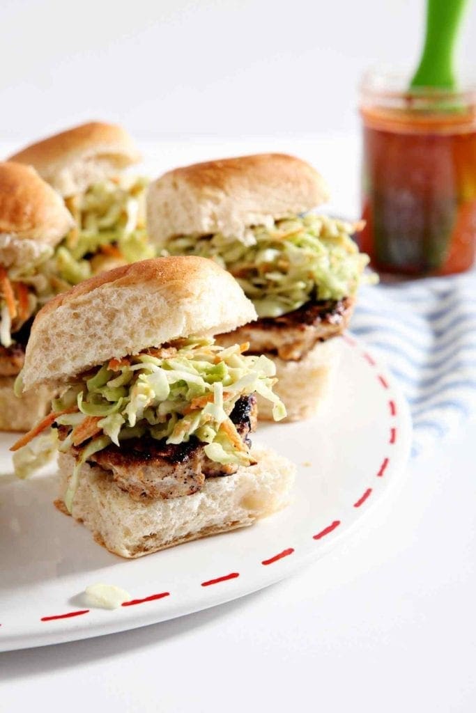 A platter of BBQ Chicken Burger Bites sits on a table before serving at a party