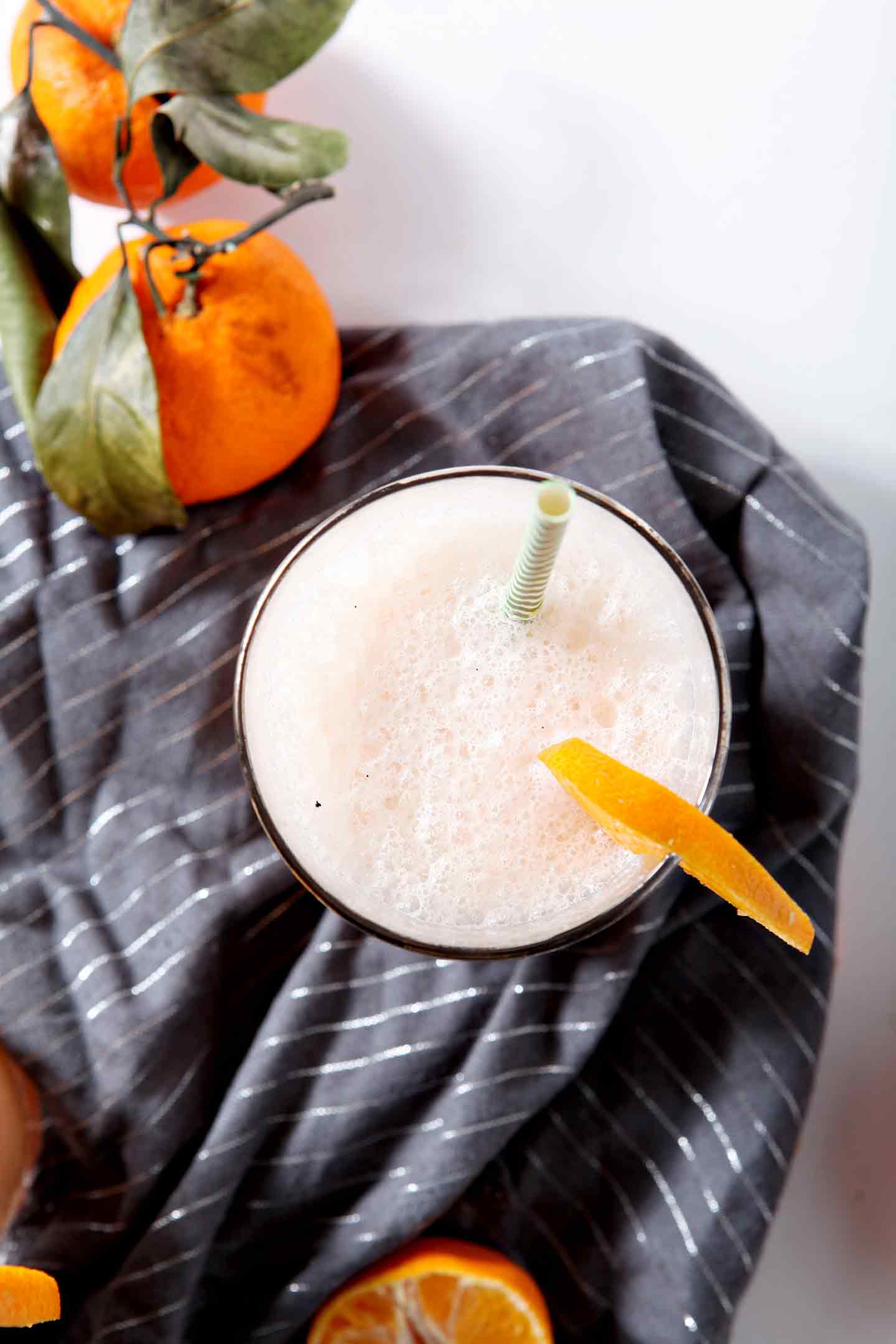 winter citrus smoothie in a glass with a grey napkin