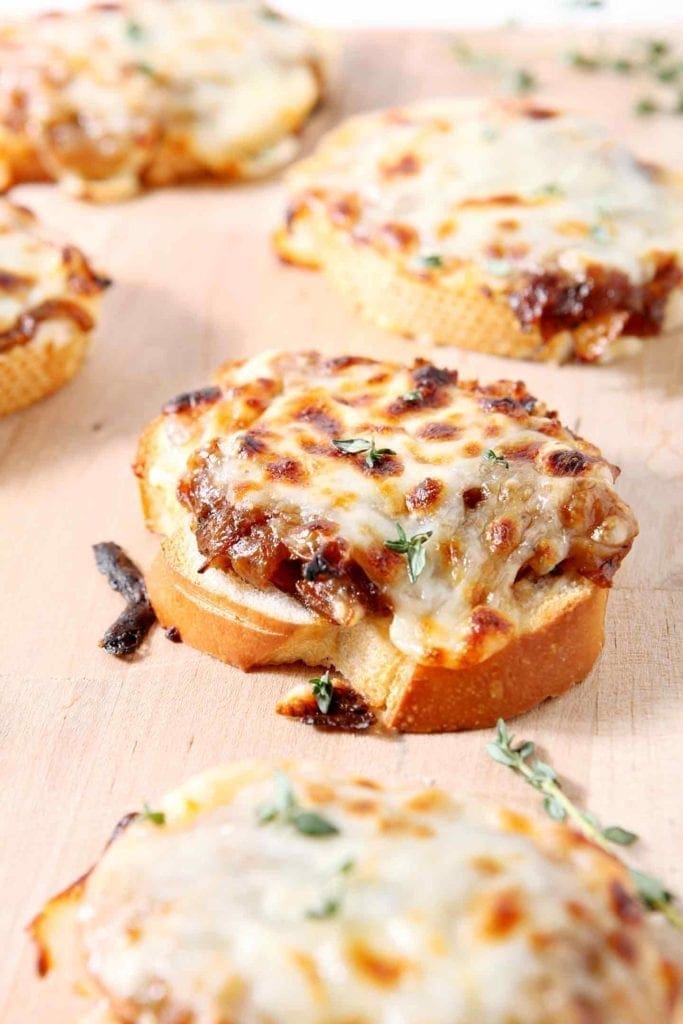 French Onion Bruschetta on a wooden serving platter