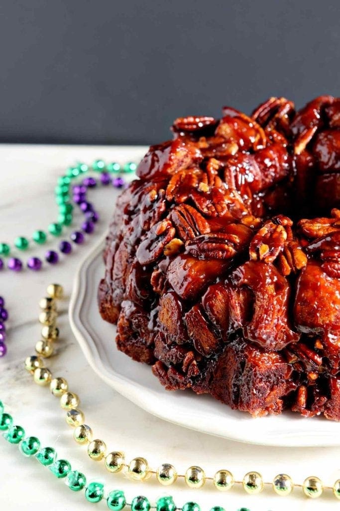 Close up of pecans and cinnamon rolls featured in an easy king cake recipe