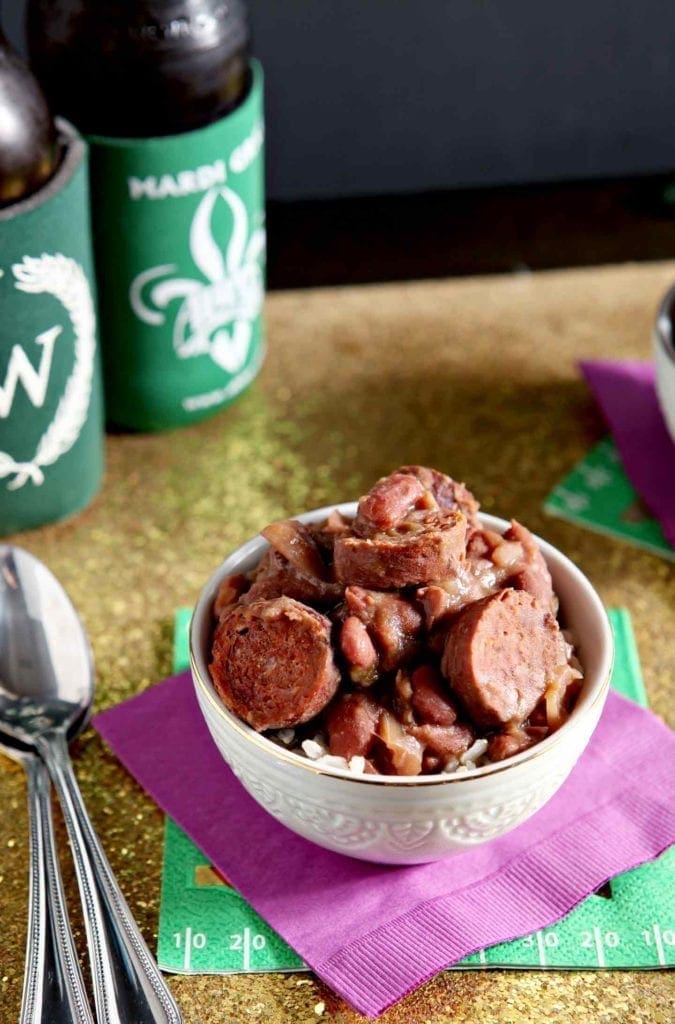 red beans and rice in a white bowl on a purple napkin