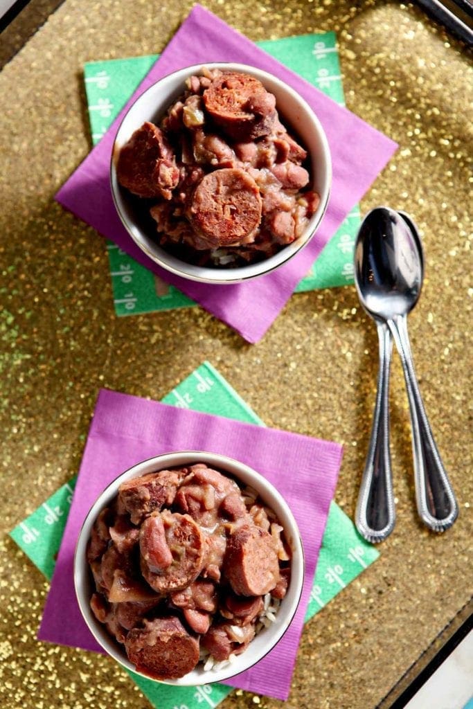 slow cooker red beans and rice in two small bowls on purple napkins