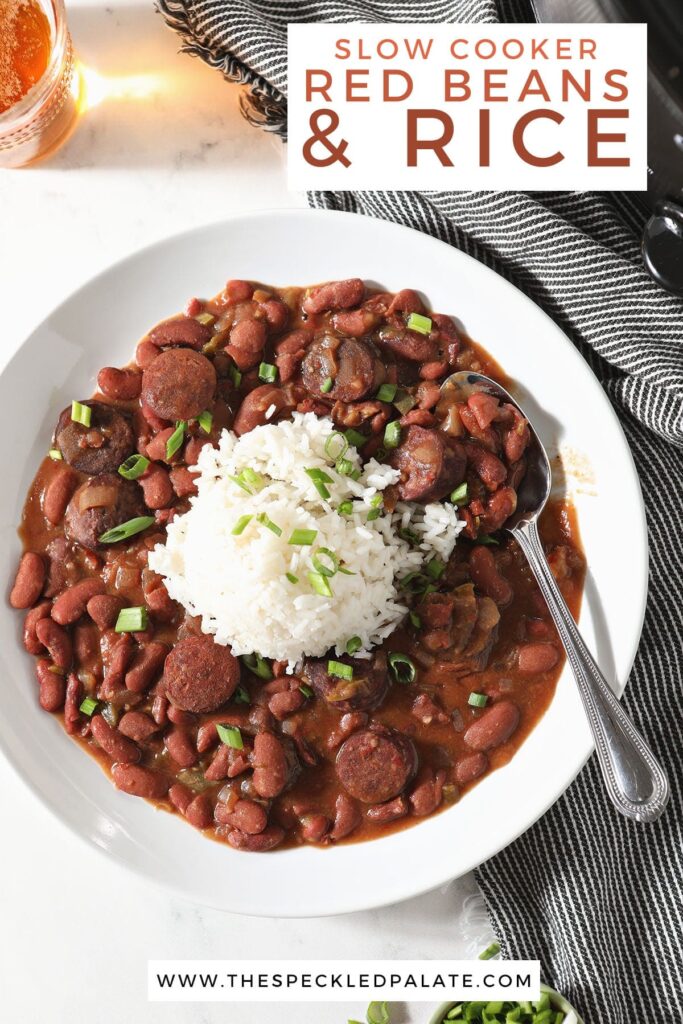 A spoon holds a helping of red beans and rice in a bowl with the text 'slow cooker red beans and rice'