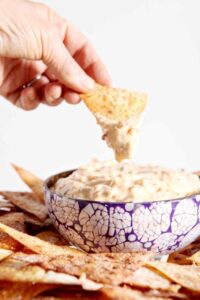 dipping a chip in carrot cake dip
