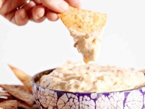 dipping a chip in carrot cake dip