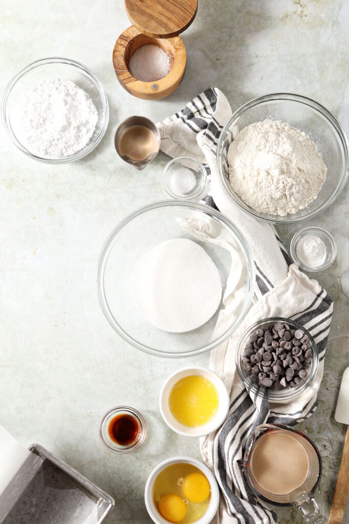 Bowls of ingredients to make a loaf cake with Irish cream on a green countertop