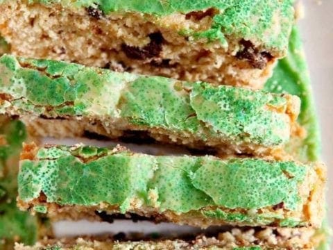 Close up of slices of a cake topped with a glaze and green decorating sugar