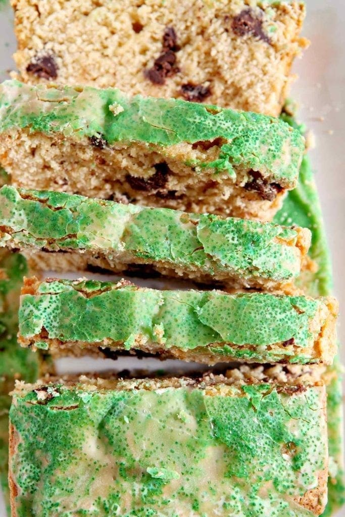 Close up of slices of a cake topped with a glaze and green decorating sugar