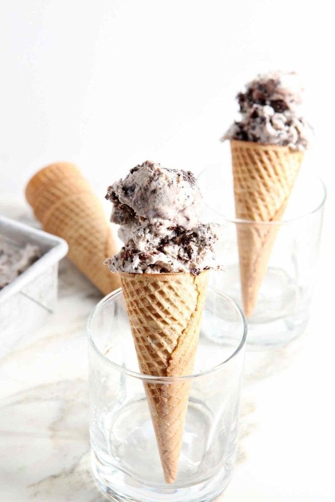 Two cones of No Churn Guinness Brownie Ice Cream are shown in glasses