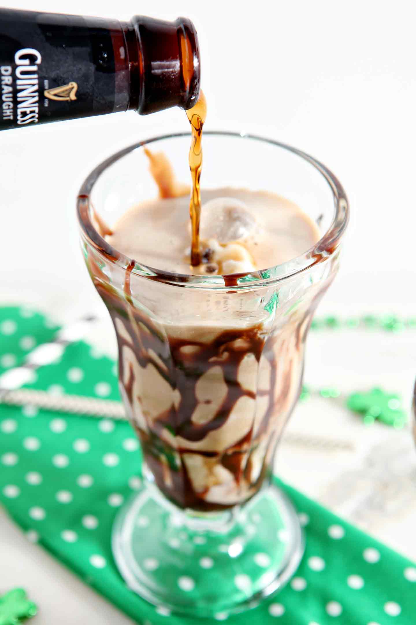 pouring guinness into a mint chip float in a glass