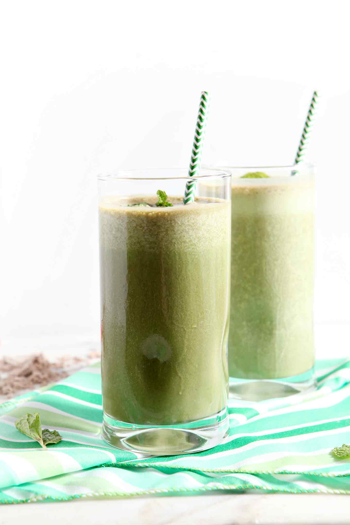 Mint and chocolate together are ALWAYS a good idea... especially for breakfast! | Thin Mint Smoothie | Vegan Smoothie | St. Patrick's Day breakfast | St. Patrick's Day smoothie | green smoothie | mint smoothie | mint chocolate smoothie Two mint smoothies with green straws