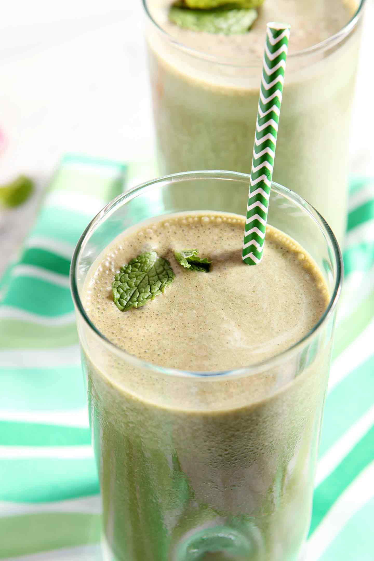 thin mint smoothie in a glass with a green straw