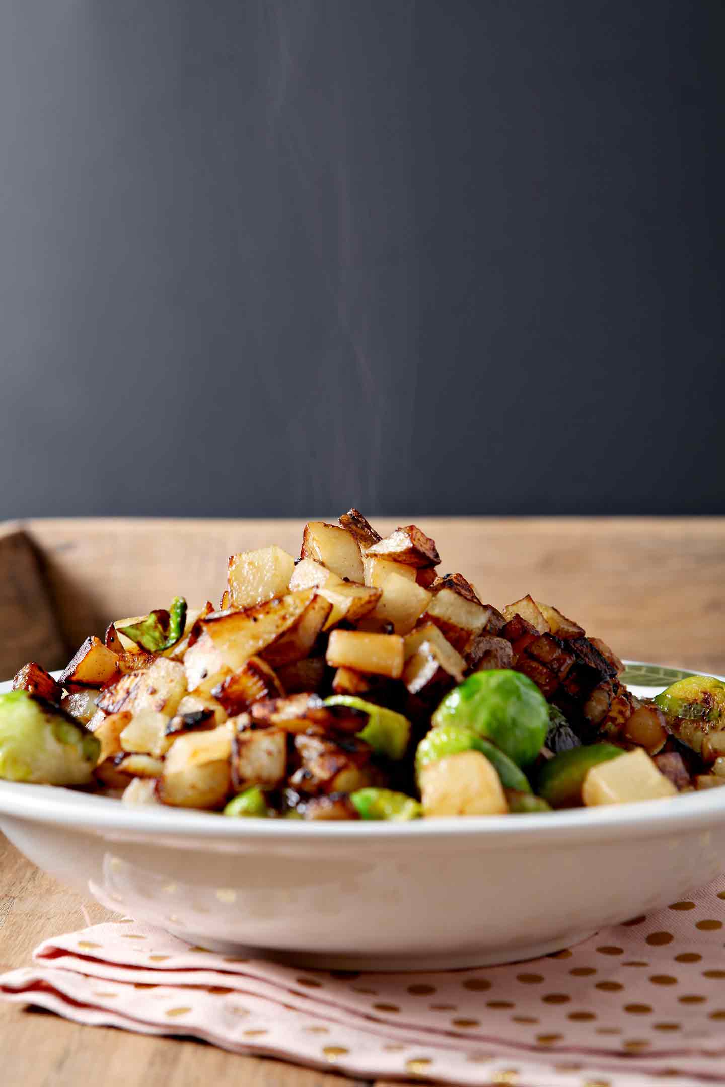 Steam rises from the hash, shown in a bowl