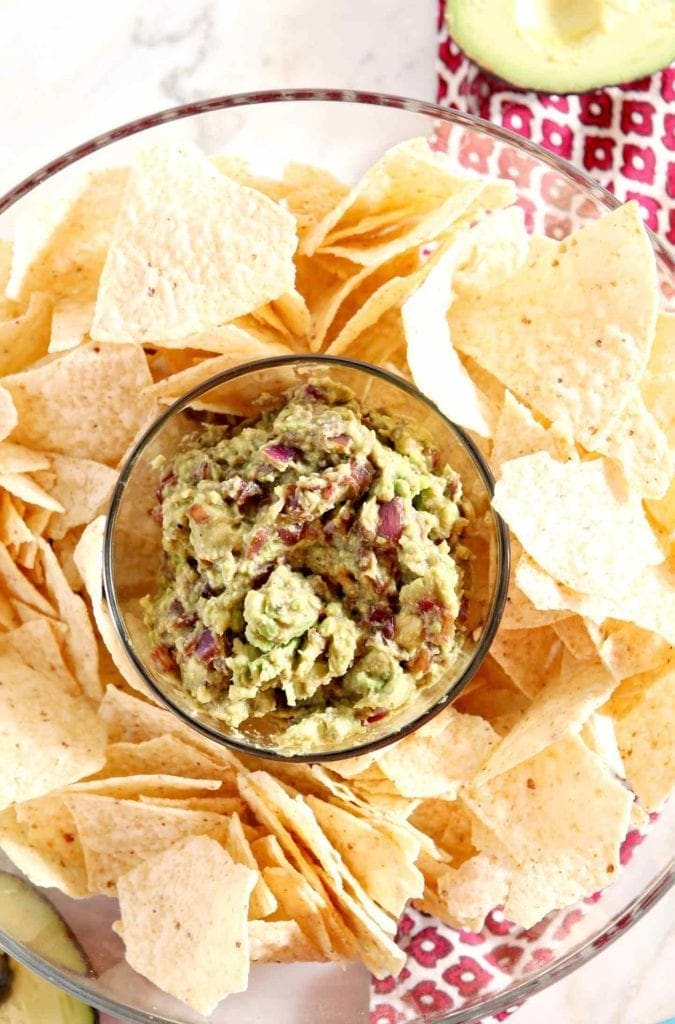 caramelized onion guacamole with chips around