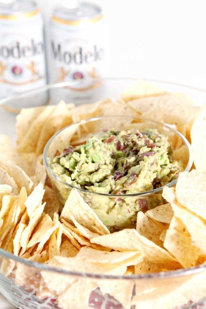 caramelized onion guacamole in a bowl with chips