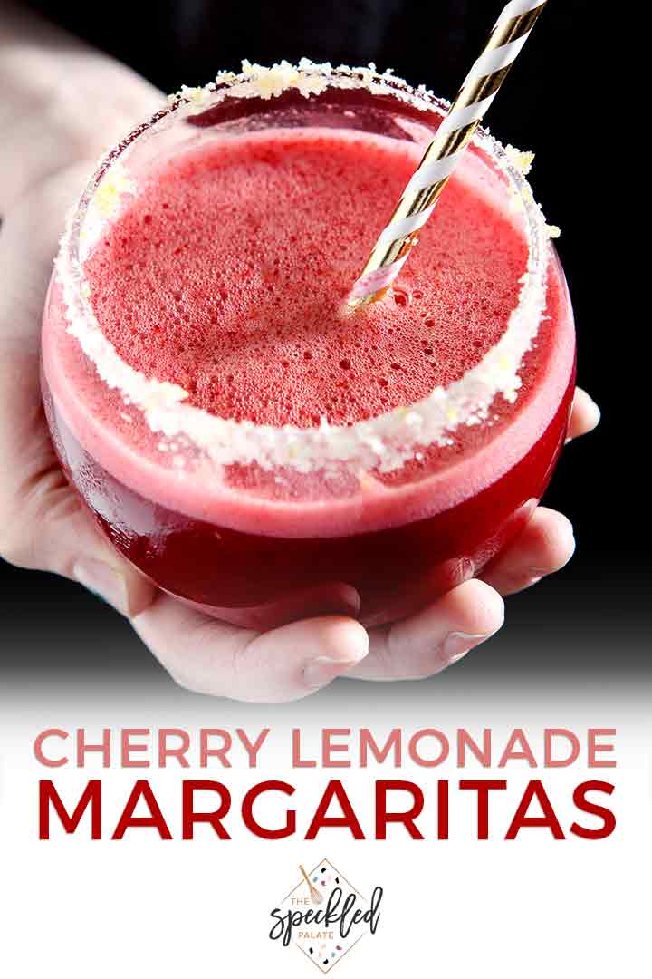 A woman holds a Cherry Lemonade Margarita in her hand with Pinterest text