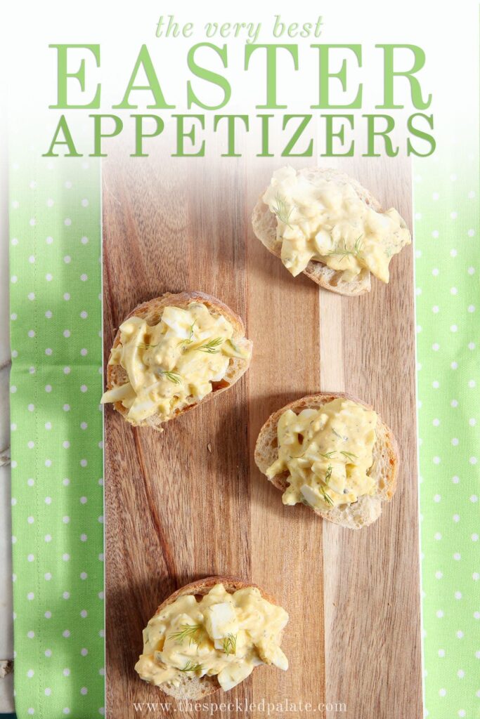 Pieces of toast with egg salad on top of them on a wooden paddle with the text 'the very best easter appetizers'