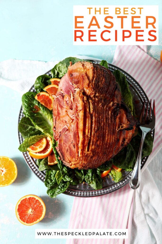 A roasted ham with sliced citrus on a turquoise surface with the text 'the best easter recipes'