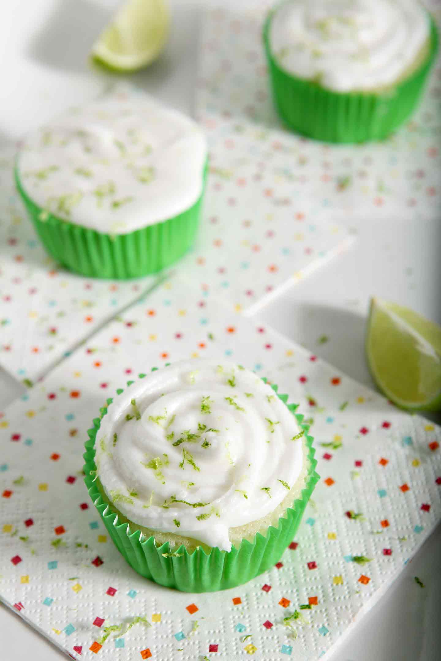 Three Margarita Cupcakes with Salted Tequila Frosting are displayed on a white tray