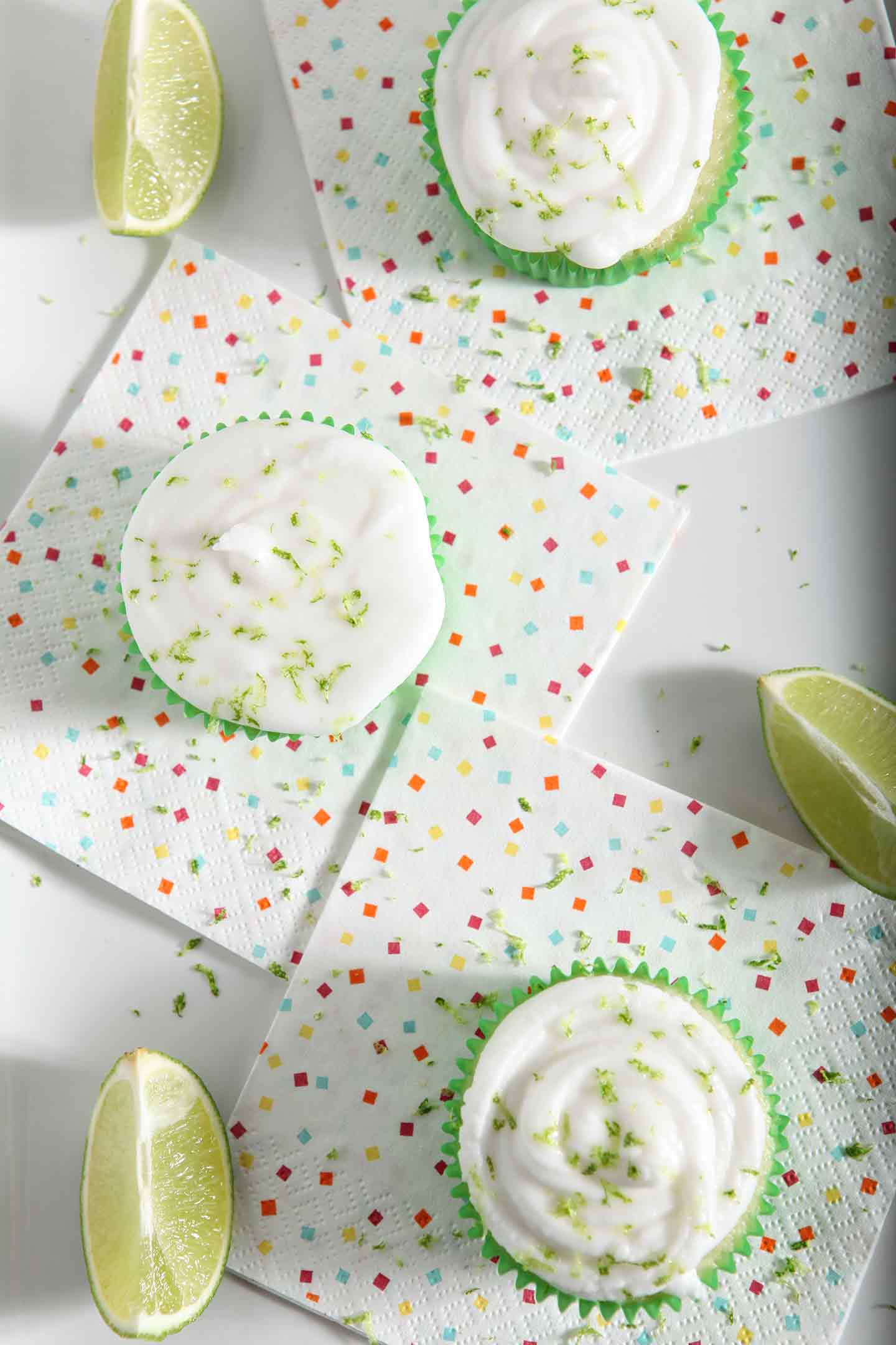 Overhead image of lime cupcakes with margarita icing, sprinkled with lime zest