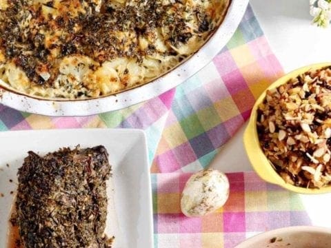 scalloped potatoes and herb crusted beef tenderloin on a table