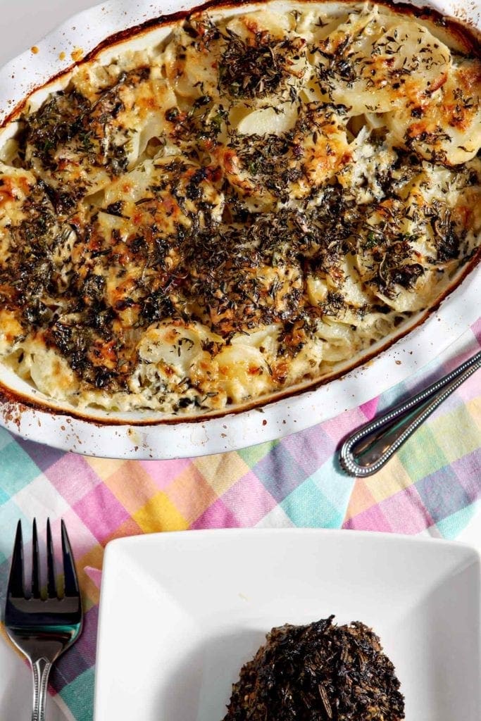 scalloped potatoes in a white baking dish