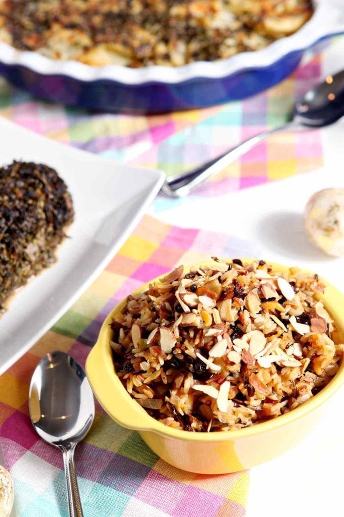 wild rice salad in a yellow bowl with a spoon