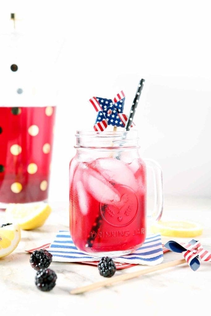 blackberry lemon whole30 tea in a mason jar with a black straw