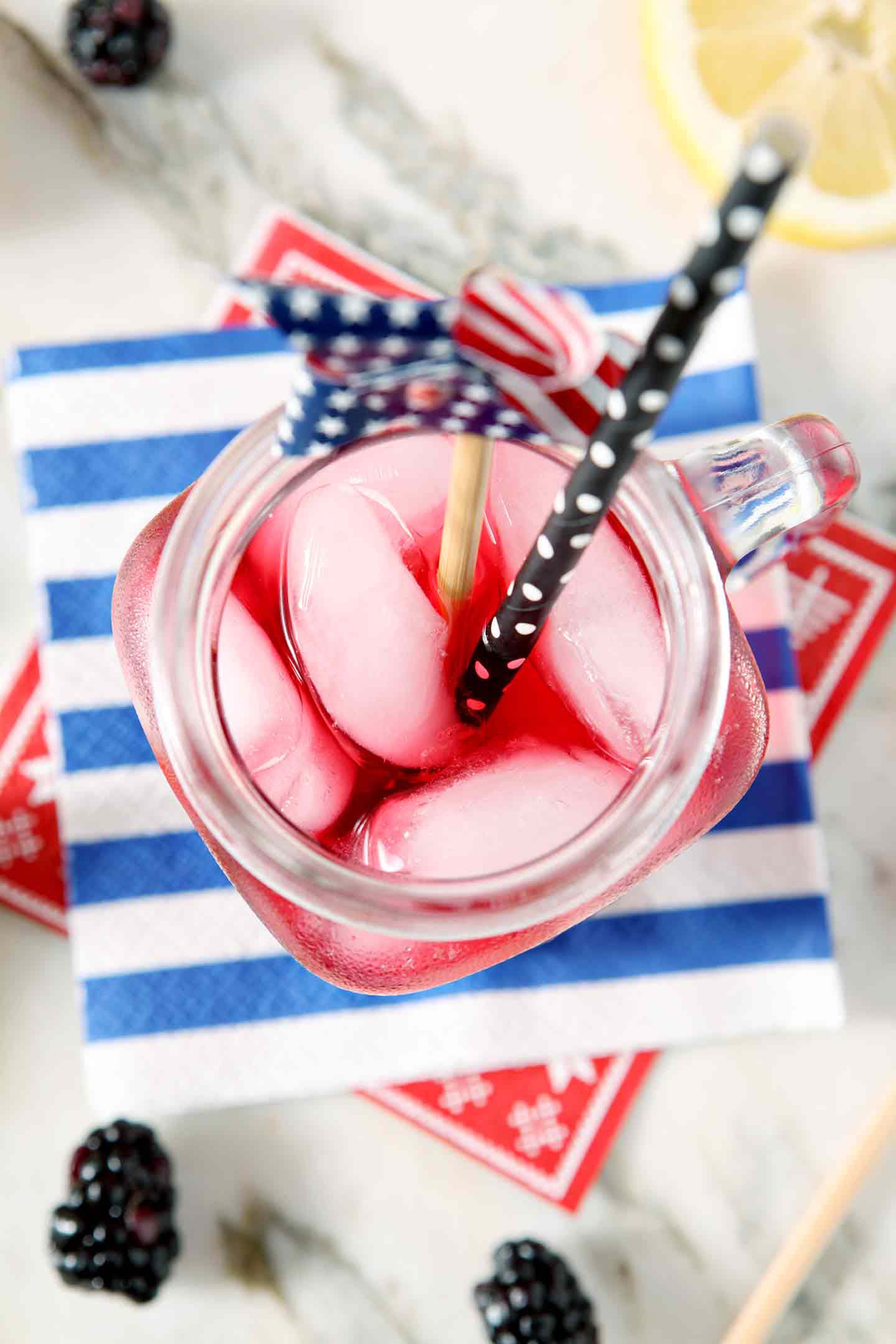 Close up of a mason jar holding Blackberry Tea with a patriotic garnish