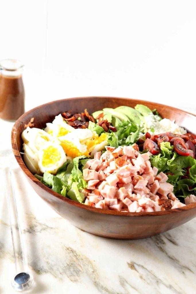 cajun cobb salad in a wooden bowl