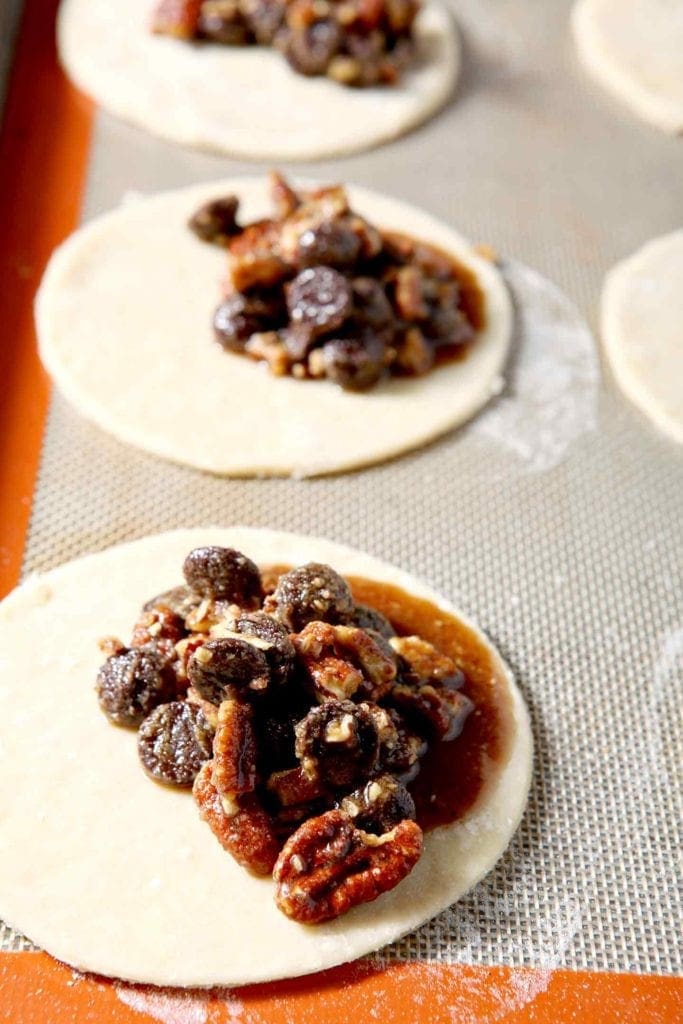 The chocolate, bourbon and pecan filling seeps out of Chocolate Bourbon Pecan Hand Pies before they bake