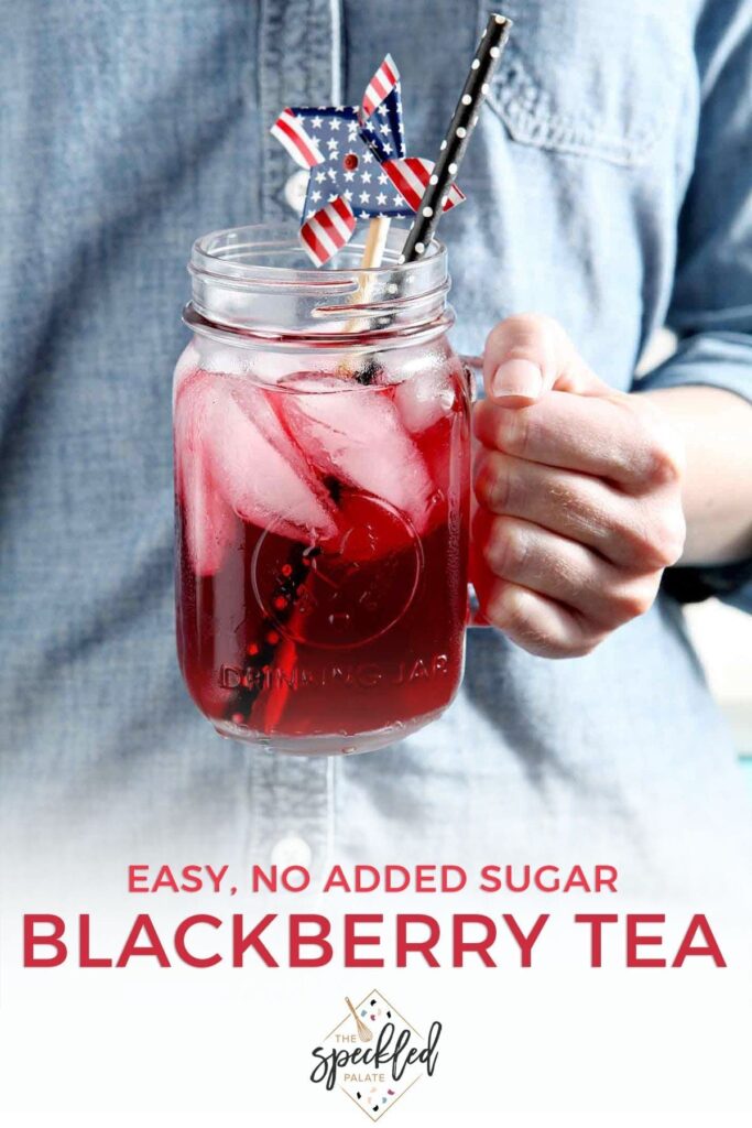 A woman wearing a blue jean shirt holds the glass of blackberry tea with the text 'easy, no added sugar blackberry tea'