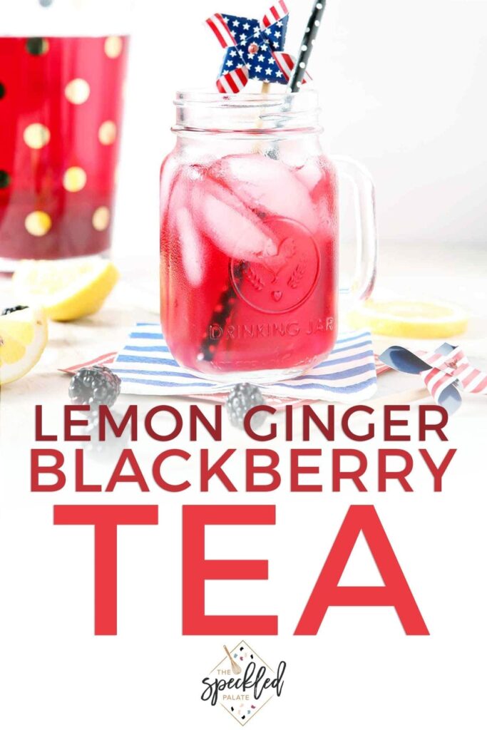 A mason jar holds a serving of blackberry tea with ice cubes and a patriotic pinwheel garnish with the text 'lemon ginger blackberry tea'