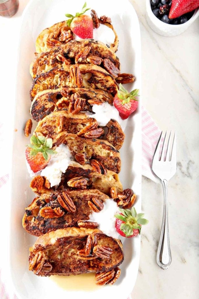 Overhead image of Dairy Free French Toast, served with pralined pecans, strawberries and coconut cream