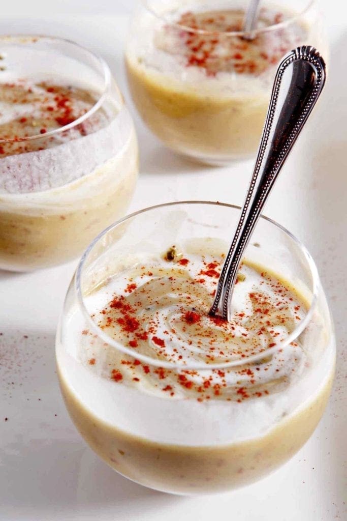 potato leek soup in glass cups with a silver spoon