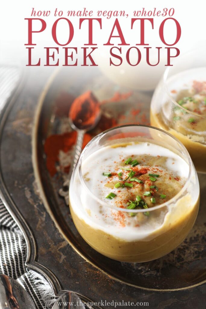 Close up of a clear glass bowl holding a serving of vegan potato leek soup garnished with additional coconut cream, paprika and chives with the text 'how to make vegan, whole30 potato leek soup'