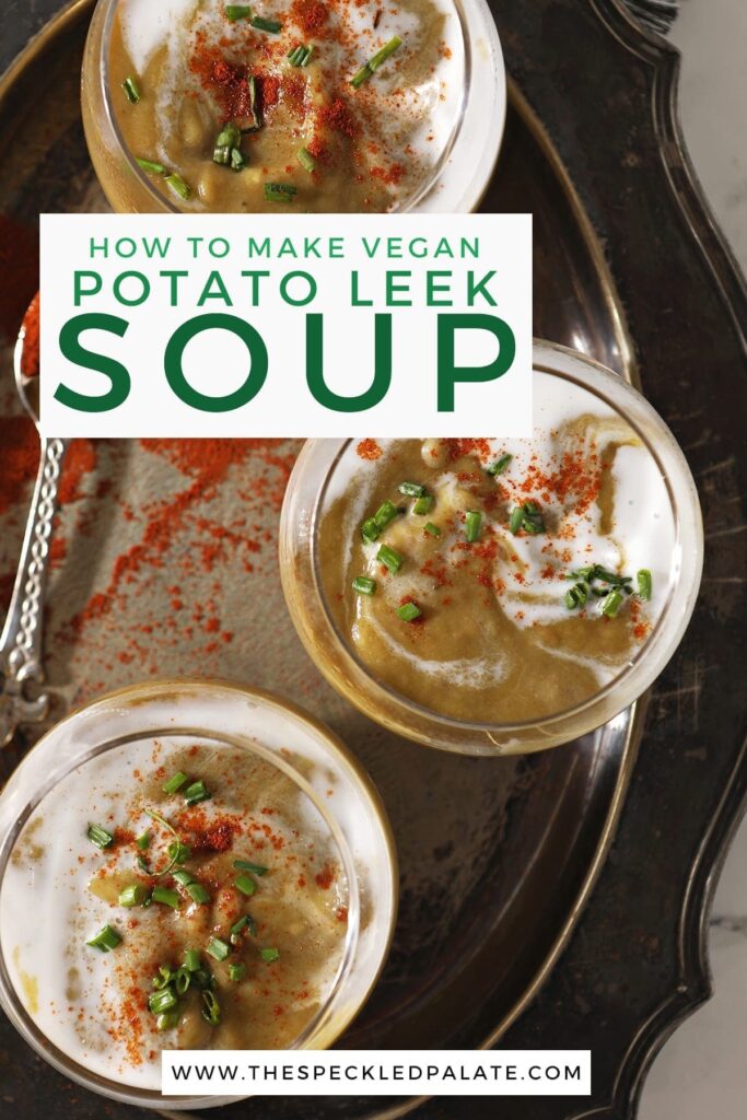 Three bowls of vegan potato leek soup from above on a silver tray next to a spoonful of paprika with the text 'how to make vegan potato leek soup'