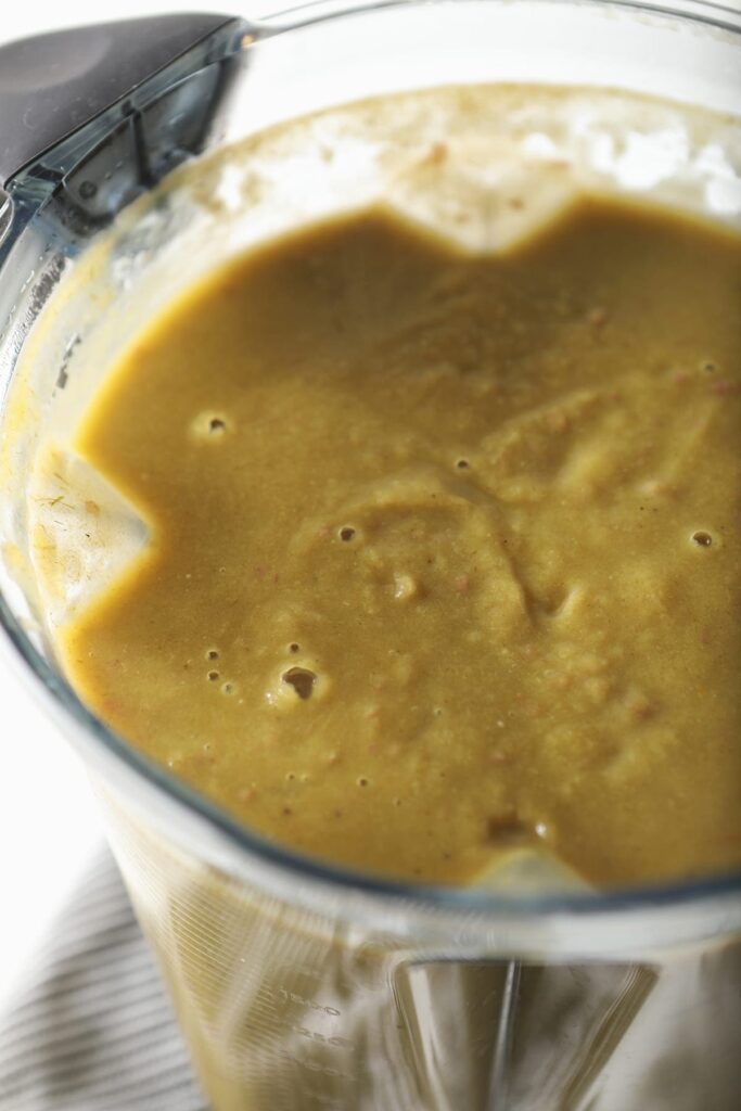 The blended soup, in the blender base