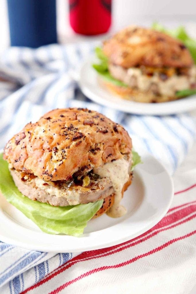 two cajun turkey burgers on white plates