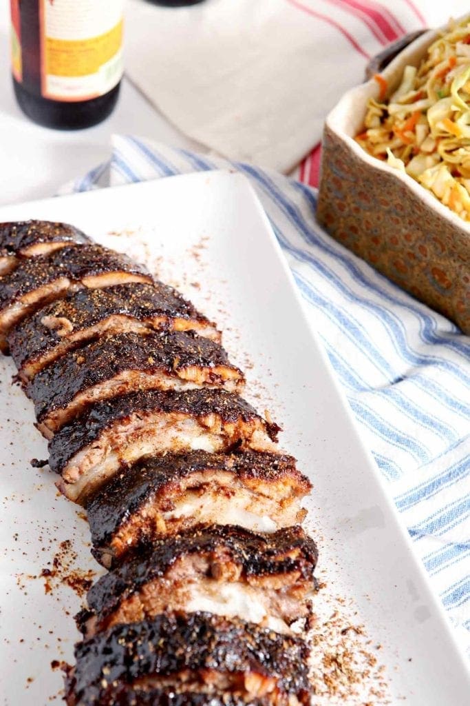 Close up of dry rubbed ribs on a platter, ready for eating