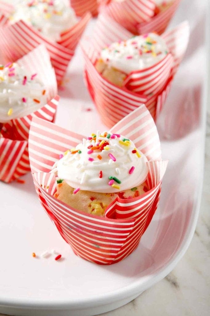 close up of a funfetti cupcake with a red wrapper