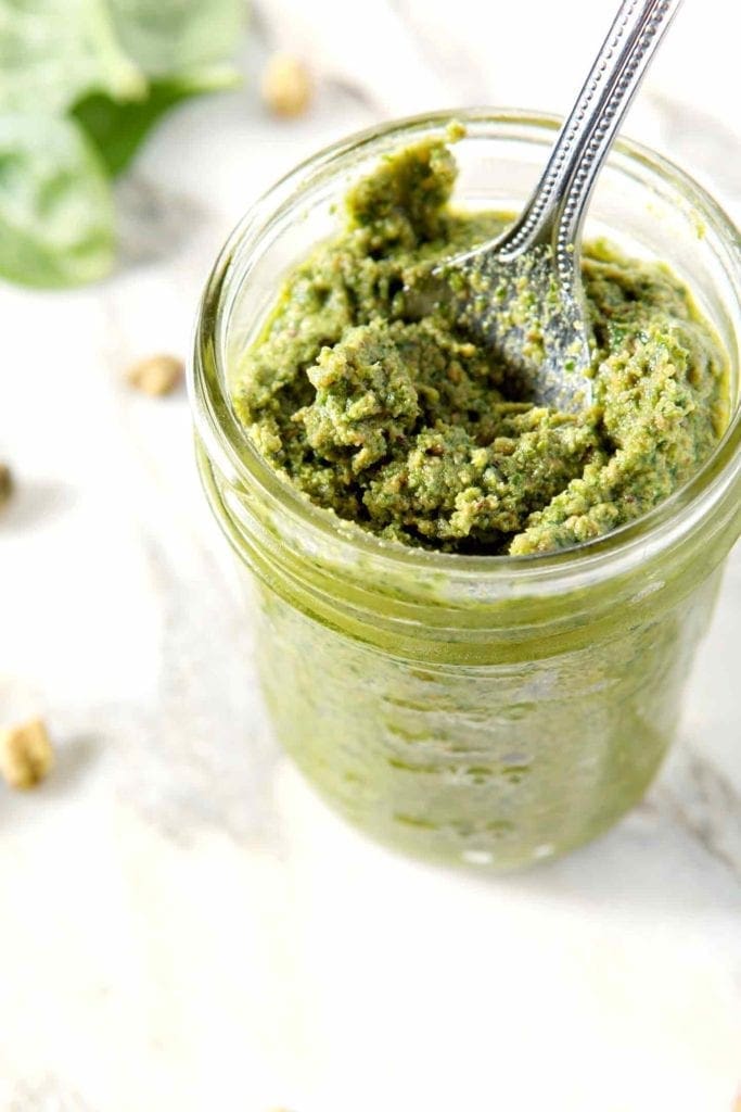 a spoon in pistachio pesto 